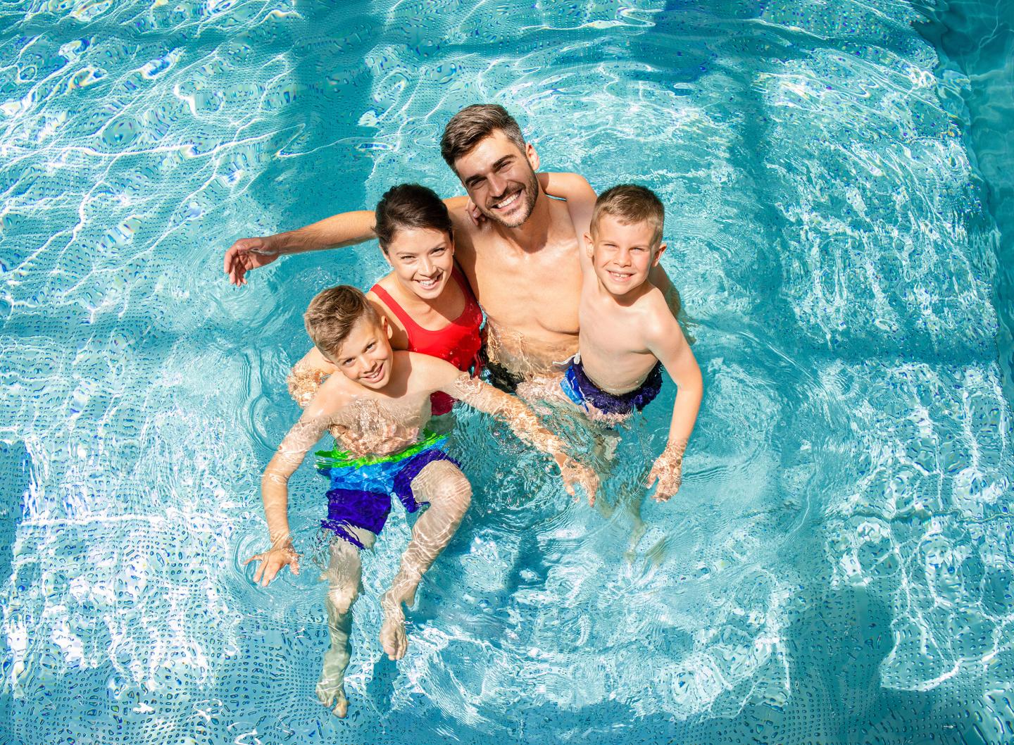 Family of four at indoor pool