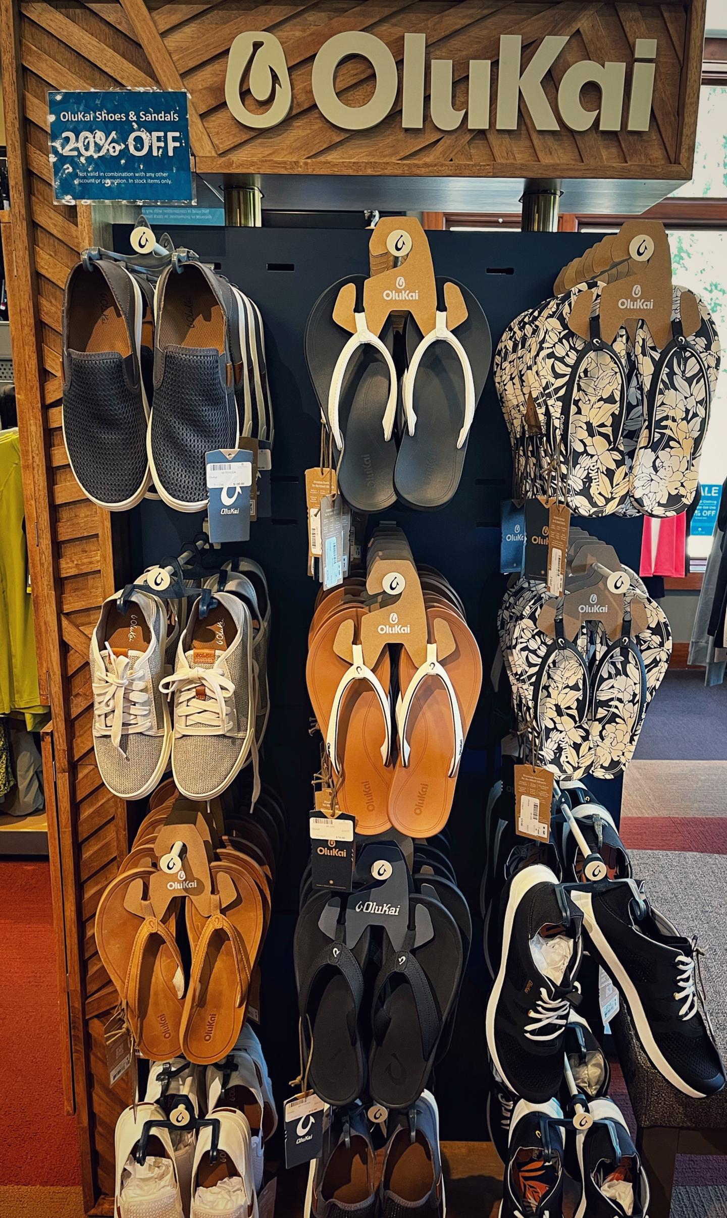 Shoe display with various OluKai sandals and sneakers at the Peak Boutique.