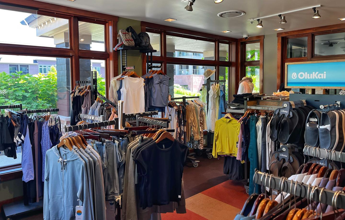 Peak Boutique with colorful shirts and pants on racks.