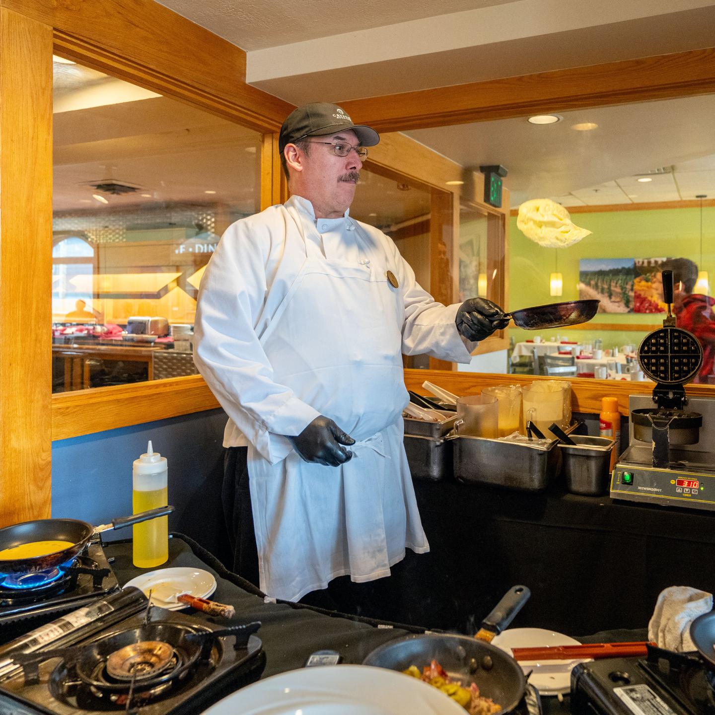 Chef cooking at Wild Tomato breakfast.