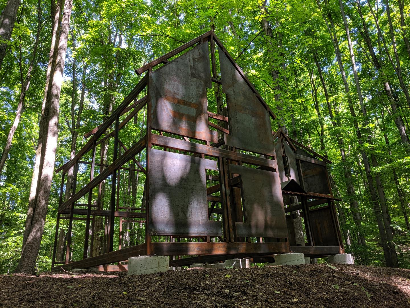 Open-frame structure in a sunlit forest.