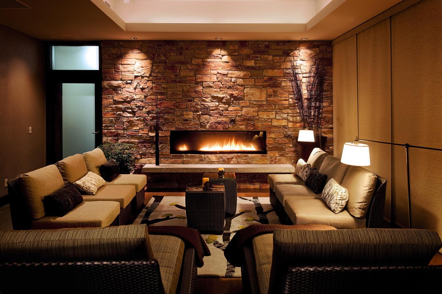 Cozy living room with sofas and a modern fireplace.