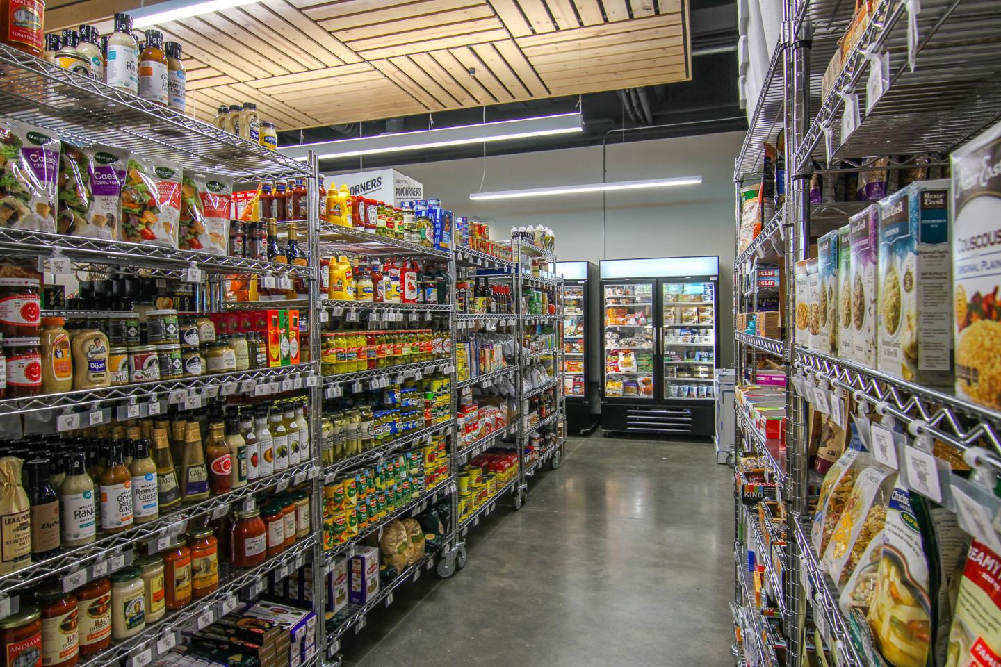 Aisle in a grocery store with shelves of various food items.