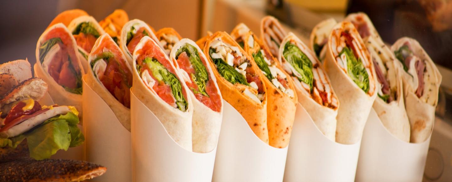 Variety of colorful wraps displayed in a row.