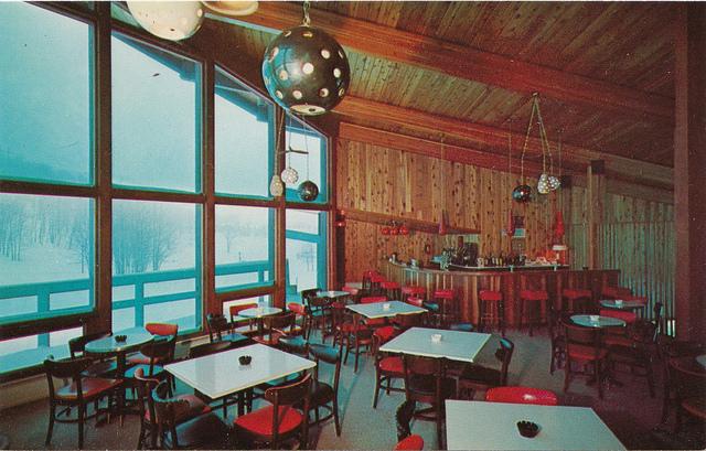 Historical Vista Lounge with tables, chairs, and large windows.