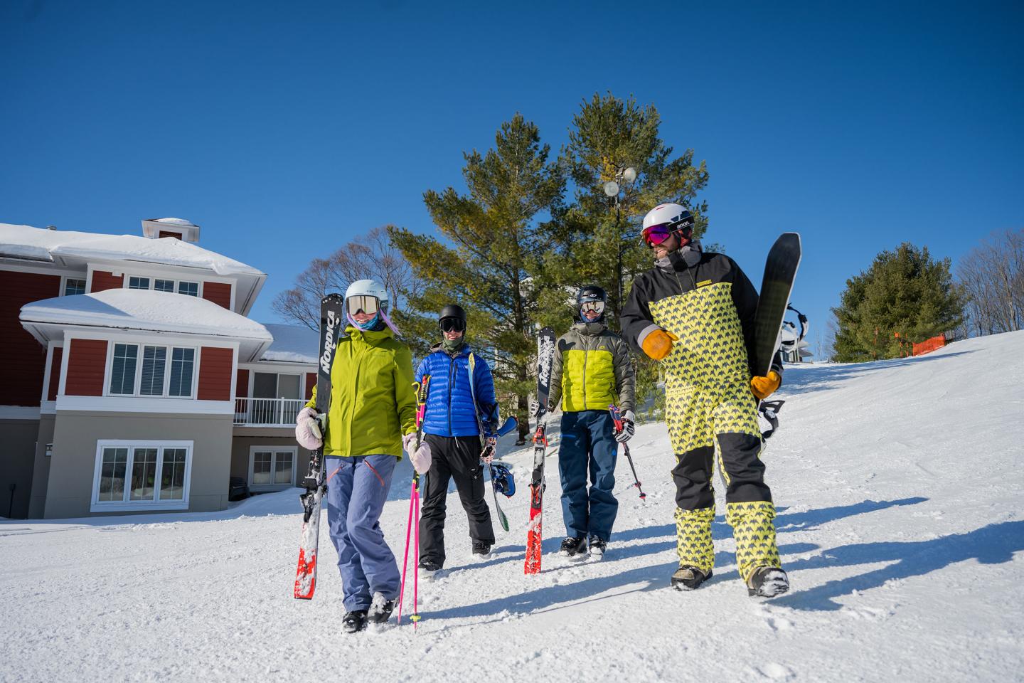 Group skiing on a sunny slope near MountainTop townhomes.